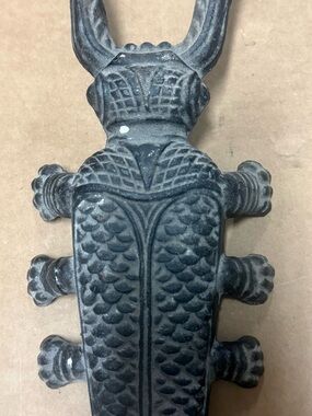 Cast iron critter, antique cockroach boot removal tool.